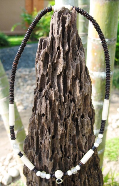 One eyed coconut shell with carved ivory amulet chain